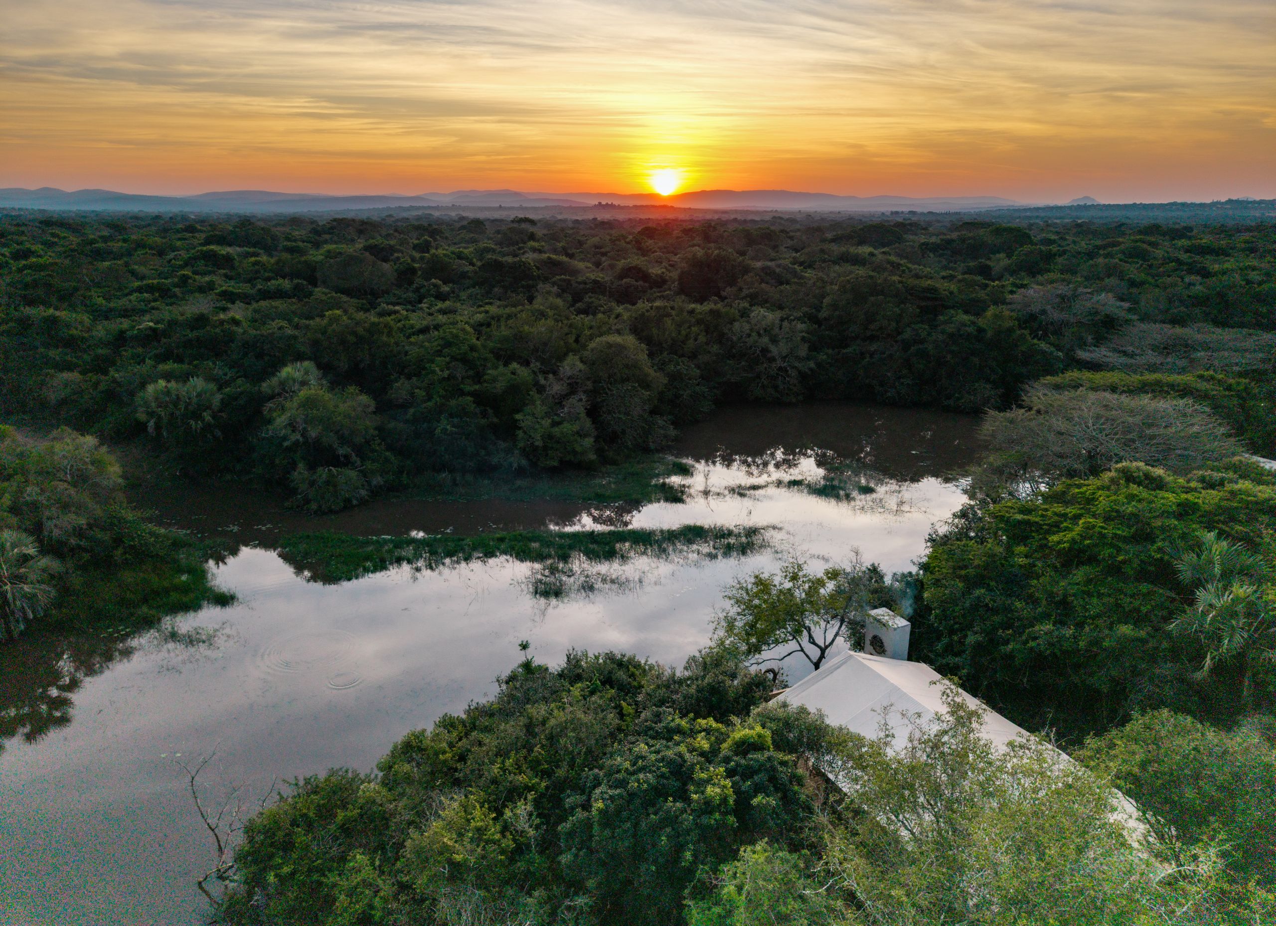 glamping tent overlooking river and sunset at africamps at bonamanzi game reserve hluhluwe