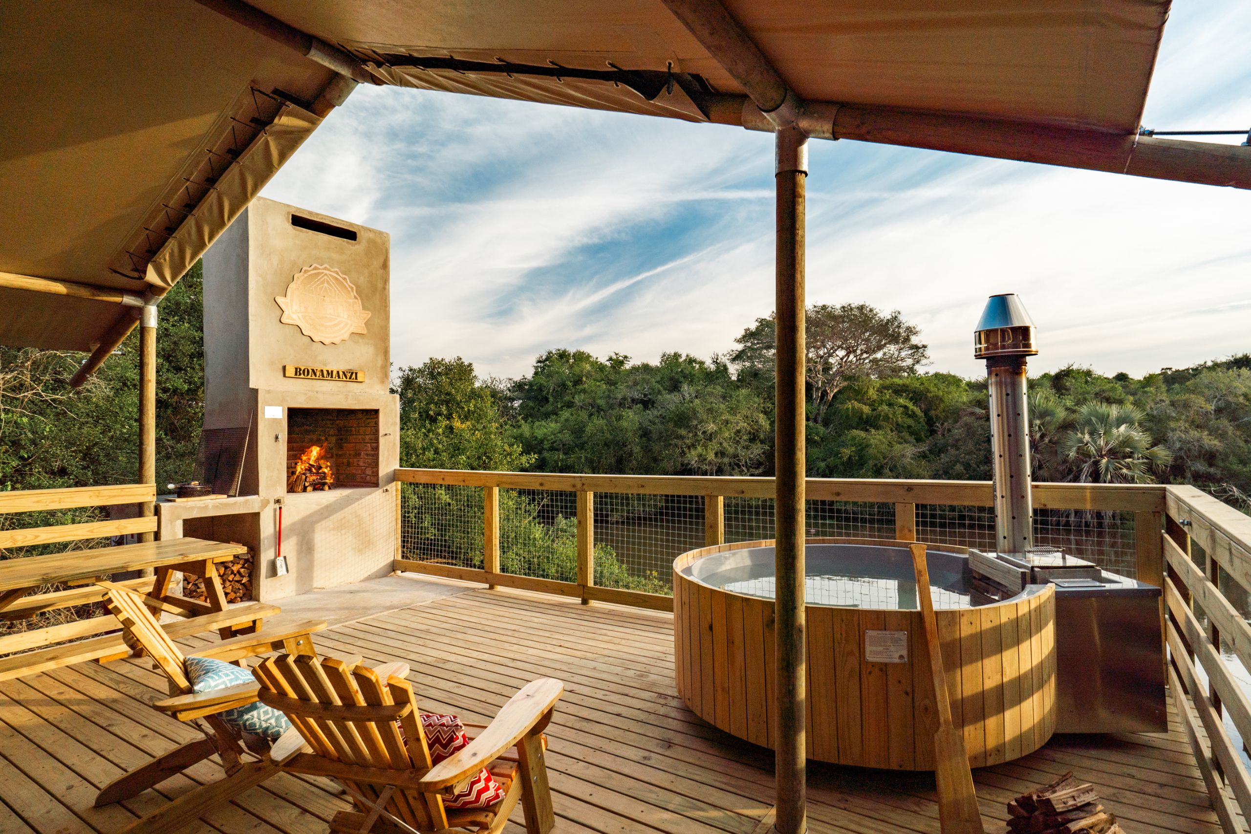 spacious outdoor deck with braai deck chairs and hot tub africamps at bonamanzi game reserve hluhluwe glamping tent
